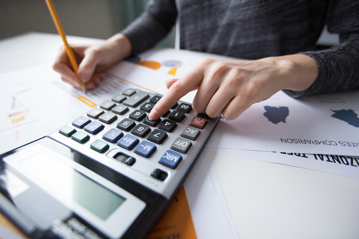 Tax consultant reviewing figures with a calculator